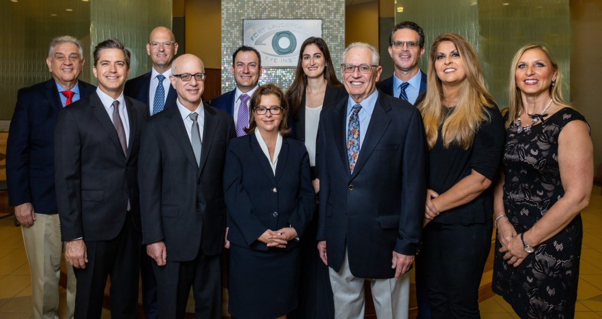 a group of eye surgeons and staff posing for a photo